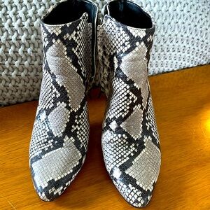 Black and white snake skin heeled boots.